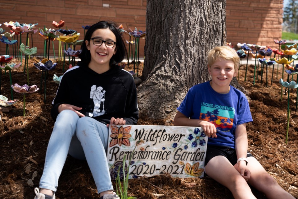 Lyons Elementary School's fifth grade students Amanda Gonzalez and Birch Eyster at the school's Wildflower Rememberance Garden installation on May 13, 2021 | Photo by Caroline Chutkow