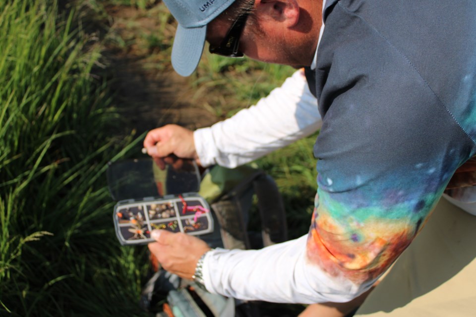 Ryan Kazee searches through an assortment of flies to match insects flying around Big Thompson River