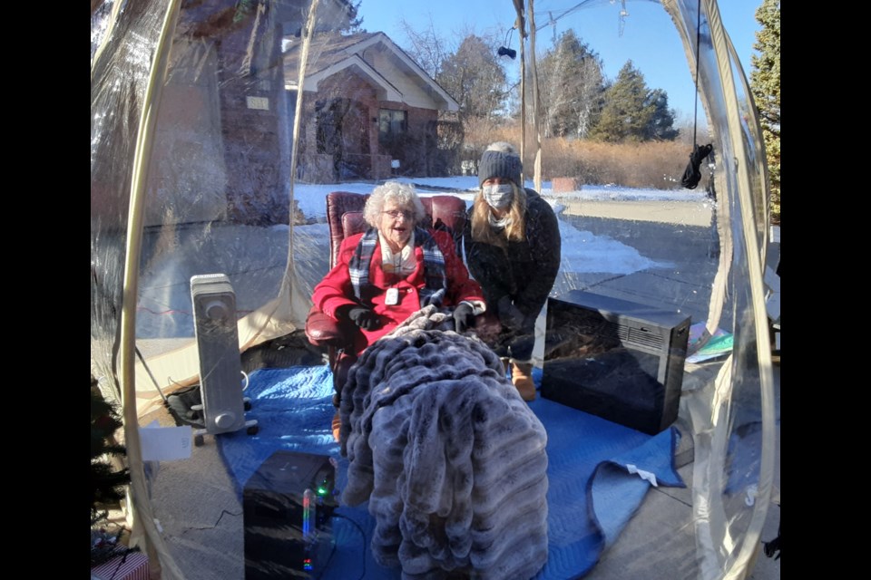 Fran McCarty is joined in her protective parade bubble by one of her seven grandchildren on Saturday, Dec. 19, 2020, in Longmont. 