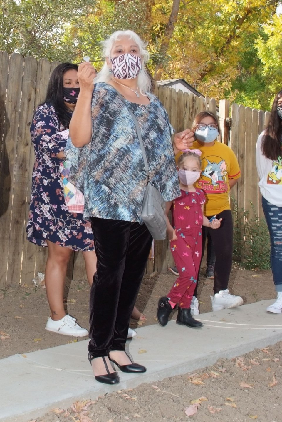 Ana Murango and her granddaughters celebrate receiving their new home