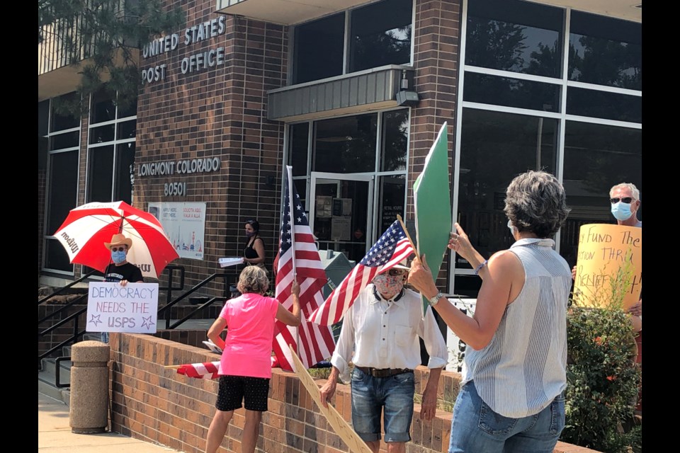 Shari Malloy and other Longmont residents gather outside Coffman St. post office in support of mail-in voting and the USPS. (Photo by Macie May)