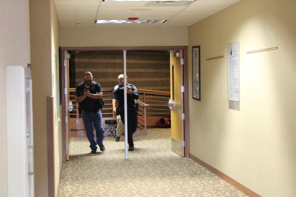 Officers stride toward a school shooting scenario at  Longmont's Altona Middle School 