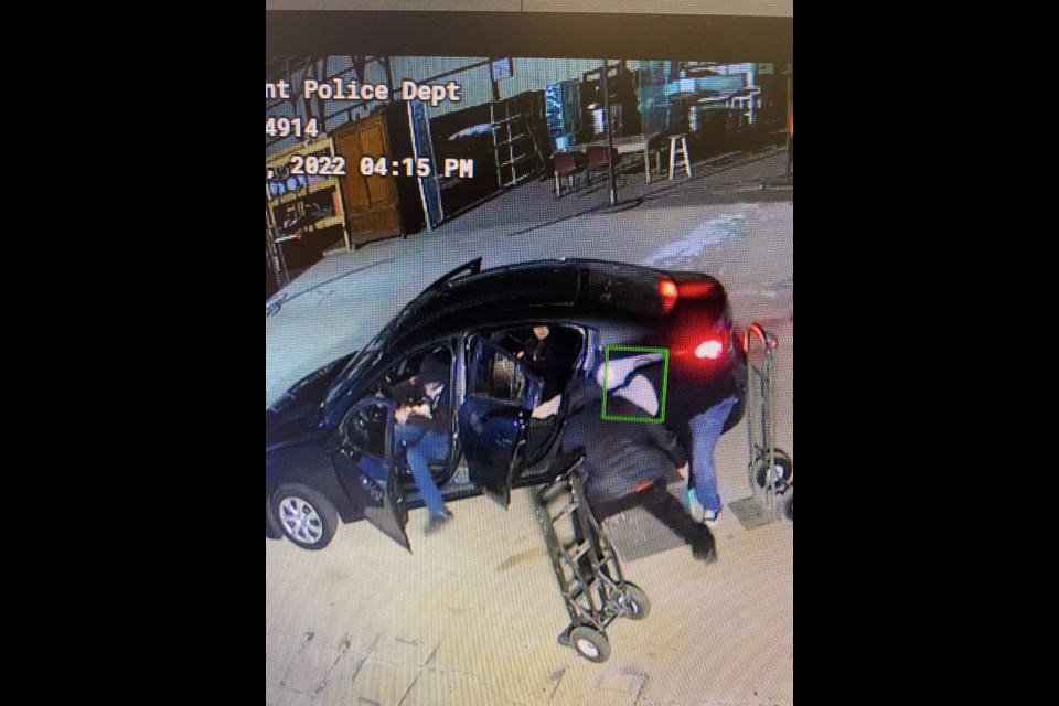 The four suspects loading their car with the stolen merchandise. All four suspects wore masks and gloves. 