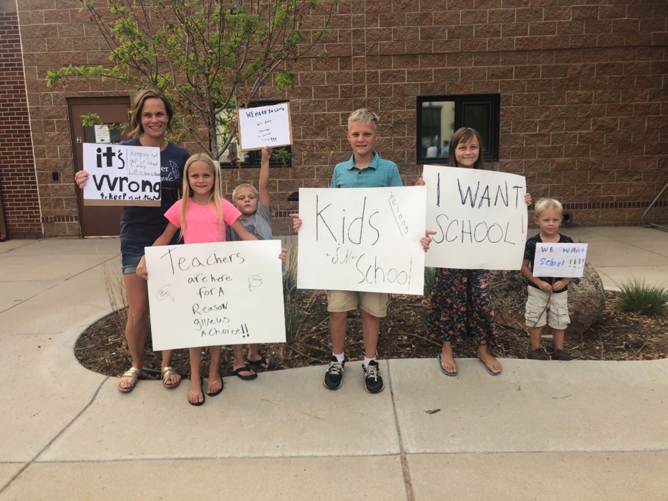 Families rally outside St. Vrain school board meeting to demand in