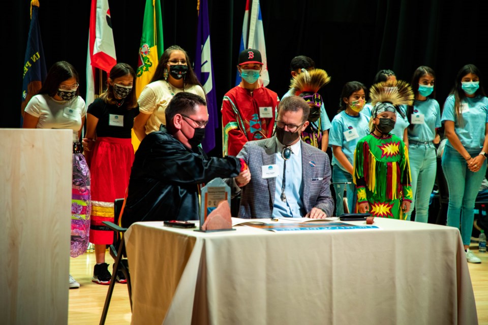 Northern Arapaho Business Councl Co-Chairman Lee Spoonhunter and Longmont Mayor Brian Bagley sign the historic Sister Cities Agreement.