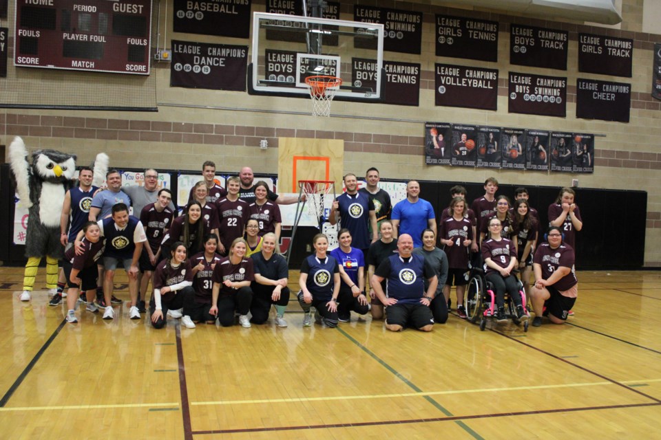 Players from both teams join in a game celebrating photo