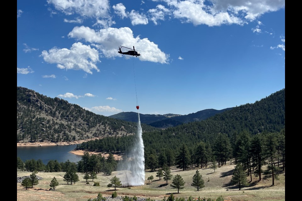 A COARNG Black Hawk practices a spot drop on a target near Button Rock Reservoir.