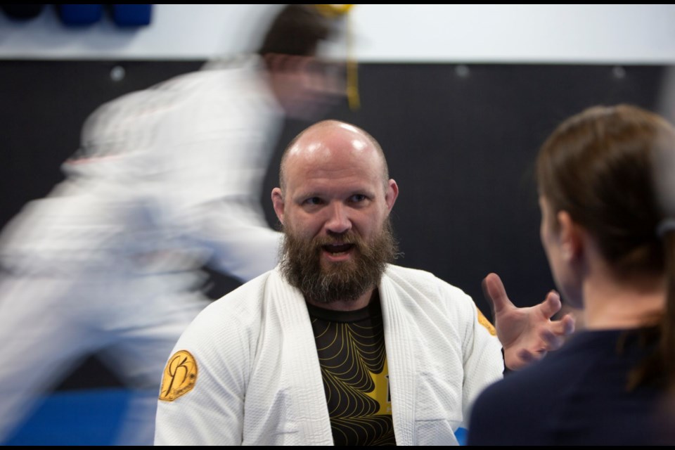 Professor Andrew Dudderar and Macie May at Dark Horse Brazillian Jiu-Jitsu doing a lesson on self-defense (Photo by Rick Brennan/ Longmont Observer)