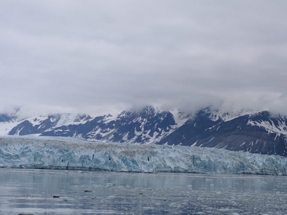 Dwarfed by the mountains, the towering Hubbard Glacier looks small. Photo by Teri Beaver.