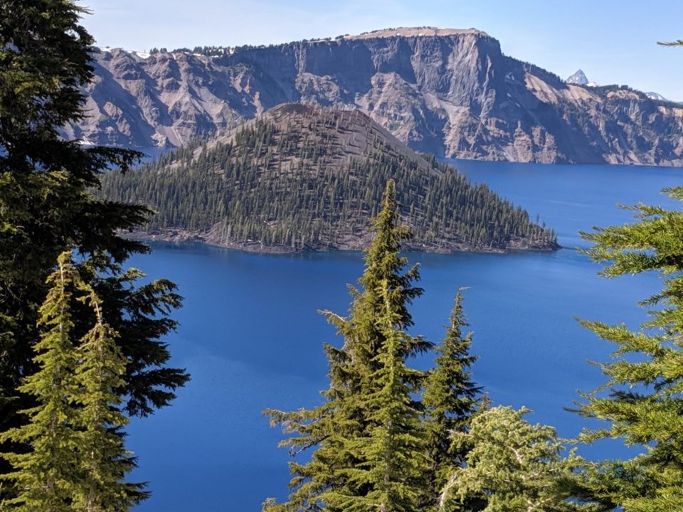 Wizard Island, gracing the west end of Crater Lake, while one of many volcanic cinder cones, is the only one that can be seen above water level. Photo by Teri Beaver.