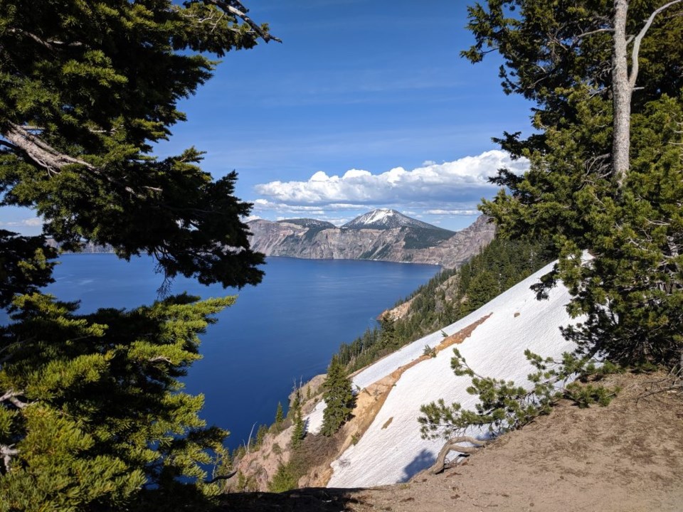 Even in summer, snow clings to the steep banks of Crater Lake. Photo by Teri Beaver