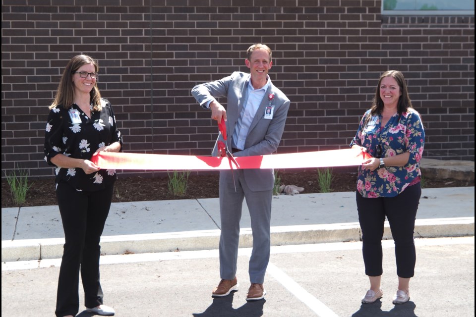 UCHealth Longs Peak Hospital's vice president of operations Stephanie Koenig, left, president Ryan Rohman and director of support services Stacie Radford cut the official ribbon to celebrate the completion of several expansion projects, including the launch of the new rooftop helipad on Tuesday, July 8, 2025 in Longmont, CO..