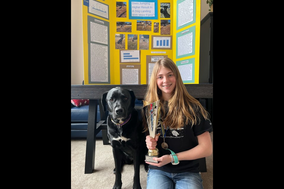 Flagstaff Academy sixth grader Mandy Roth poses with Kimmie the dog, who helped Roth with her experiment that went on to win best in show at the Boulder County Regional Science Fair.