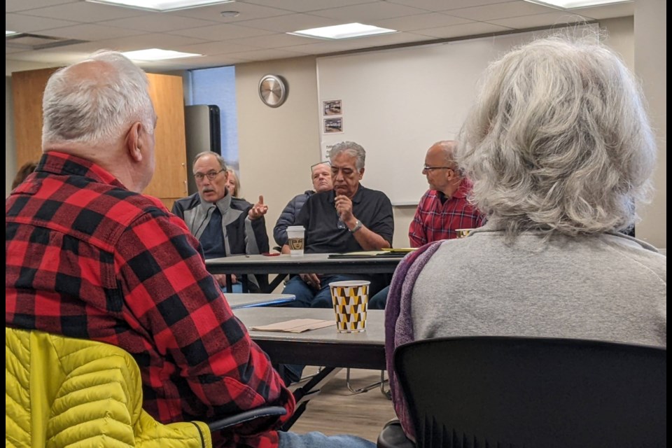 A community member asks a question about homelessness in Longmont during a conversation on Saturday with Mayor Joan Peck, right.