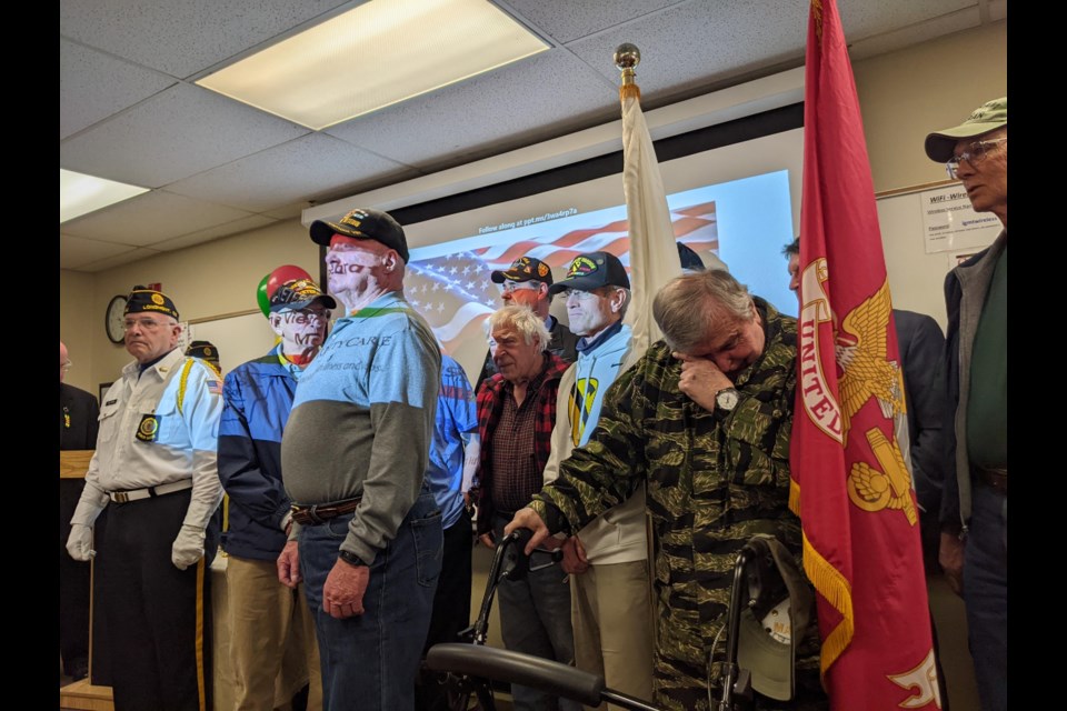 Jack Burchett wipes a tear standing with fellow Vietnam War-era veterans as they are applauded for their service during a ceremony Tuesday at the Longmont Senior Center.