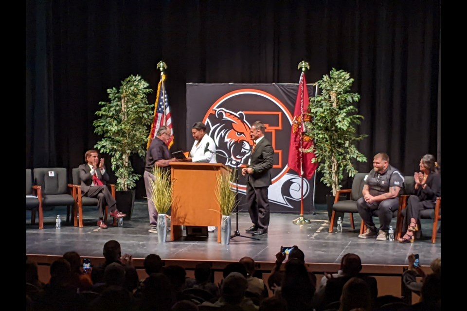 Ron Cardenas receives his diploma from school board member Meosha Brooks during a special ceremony on Friday at Erie High School