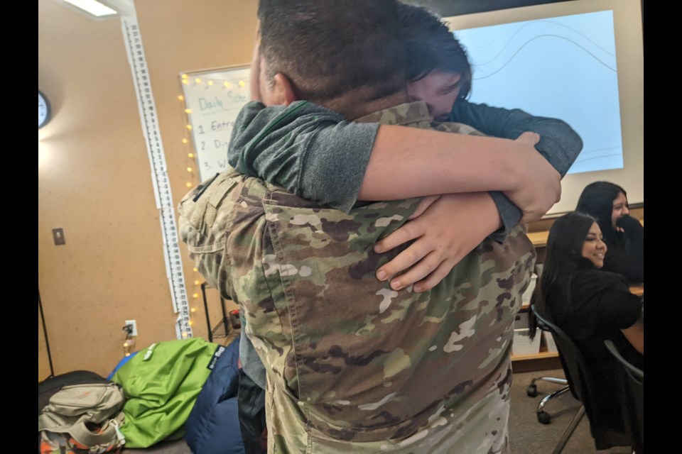 Trail Ridge middle schooler Kai Olivas embraces his father for the first time in a year.