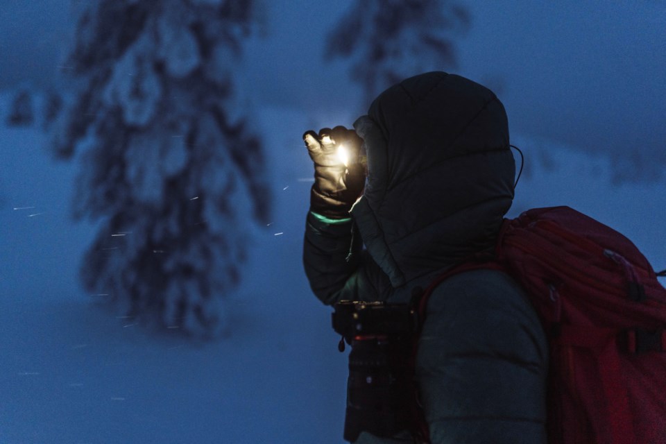 trekker-with-headlamp-walking-snowy-riisitunturi-national-park-finland