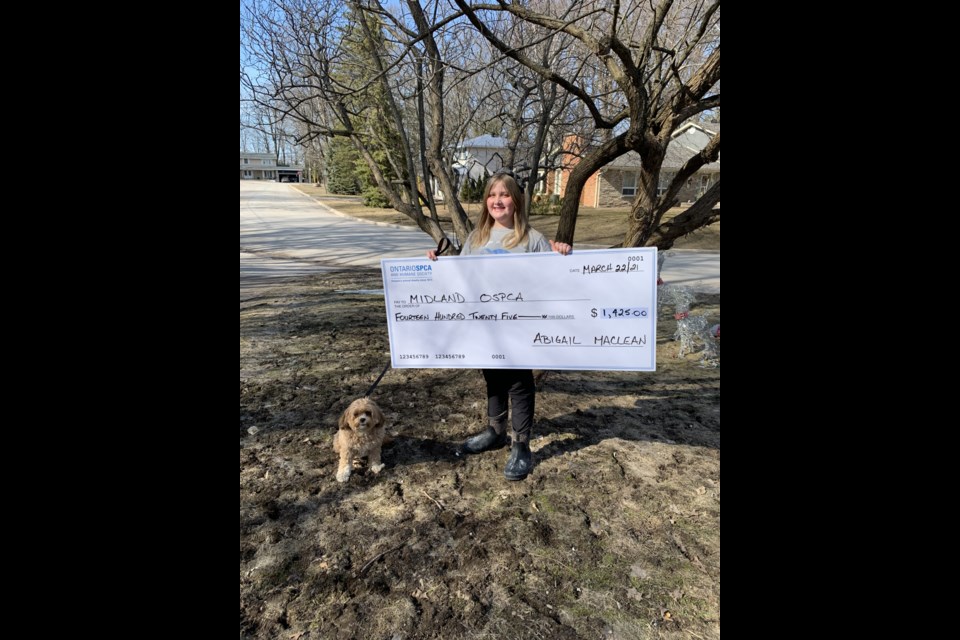Abbie MacLean, pictured with her best friend Rosco, raised $1,425 for the Midland OSPCA during the recent National Cupcake Day. Abbie and other local bakers have helped raise more than $9,000 for the Midland Animal Centre.