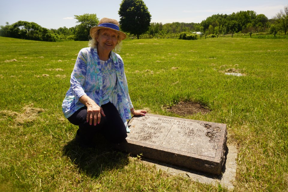 Nancy Hull is pictured a marker remembering the lives of her pets Zorro, Sparkles, Shadow, Gentle Sky, Willow and Yukon.                               
