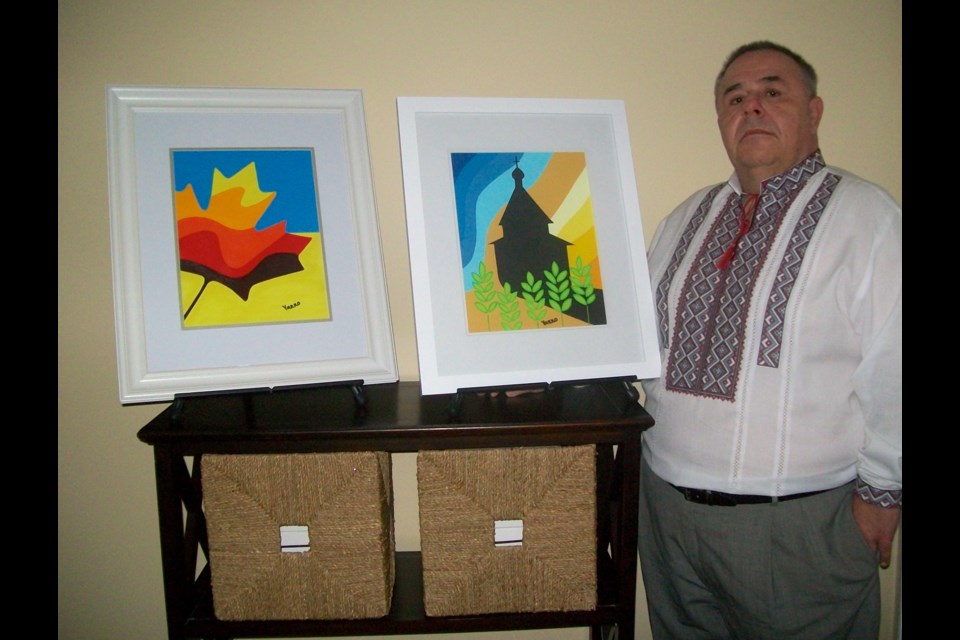  Jerry (Yarko) Kulyk is seen with a couple of his paintings.