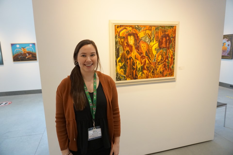 MCC marketing and promotions coordinator Michelle Feir stands in front of a painting by Daphne Odjig.

Marketing & Promotions Coordinator                          