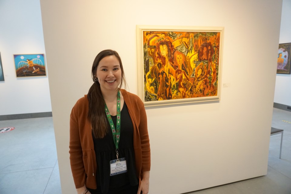 MCC marketing and promotions coordinator Michelle Feir stands in front of a painting by Daphne Odjig.

Marketing & Promotions Coordinator                          