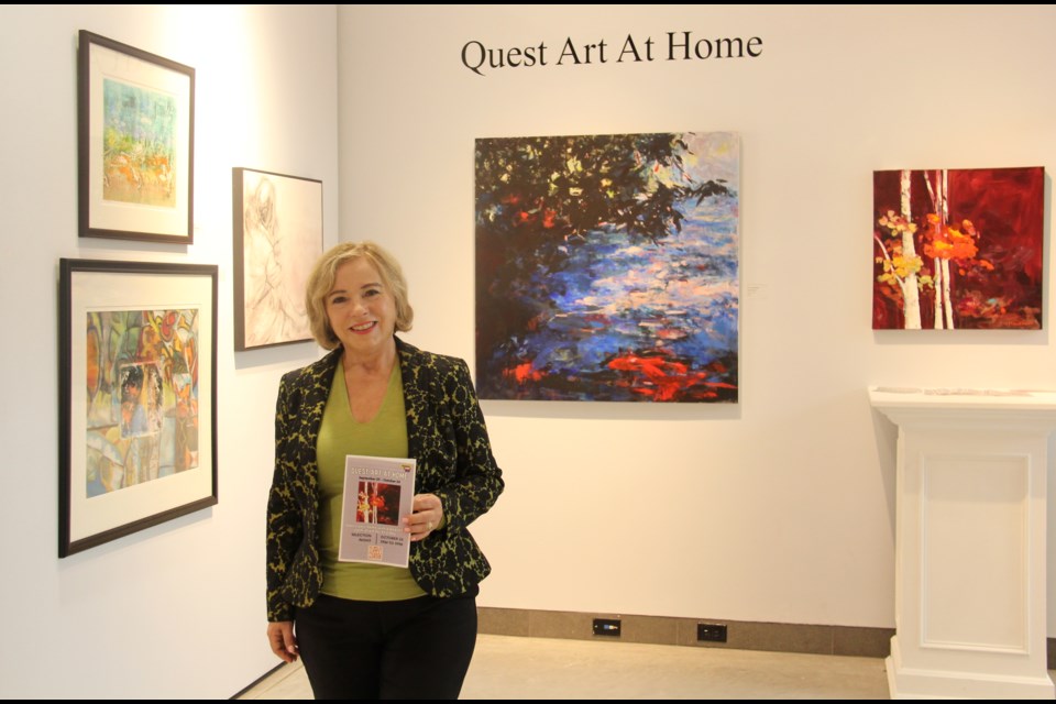 Cathy Tait, chair of the Quest Art School and Gallery, is seen with some of the art work available for a one-year loan from the artist through the Quest Art At Home project.