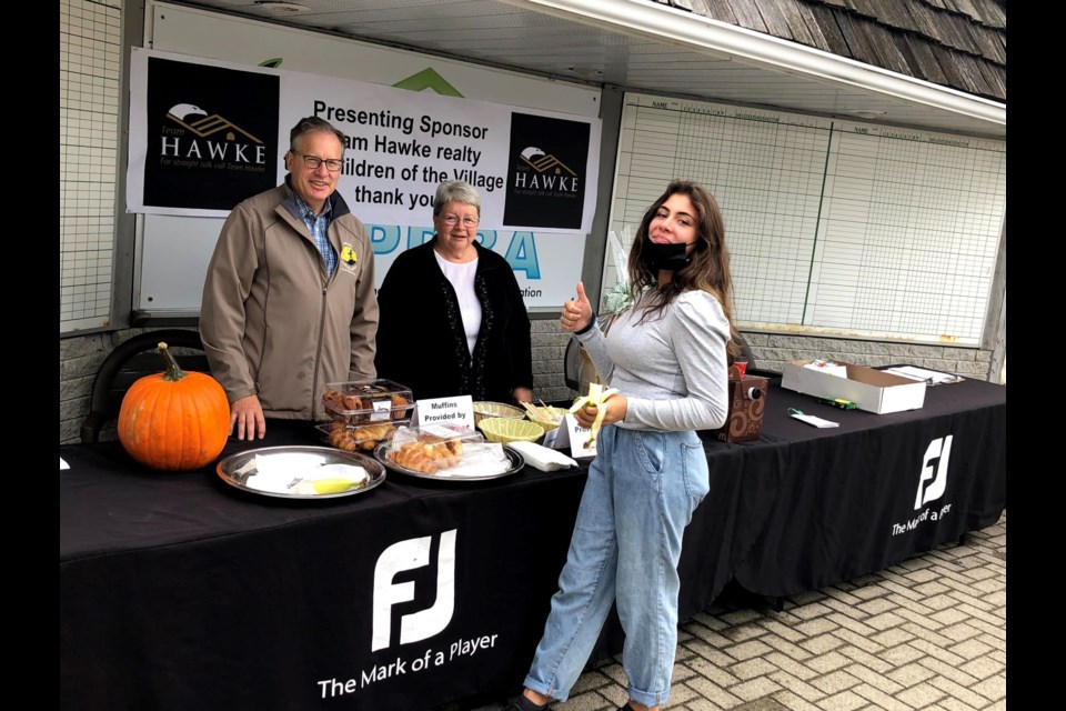 Betty Laurin, Mark Banham (board member/chief fundraiser) and a youth volunteer help out at the registration desk for We Are The Villagers annual Julianna Matyas Memorial Golf Tournament held at the Brooklea Golf Club where they raised over $13,000.