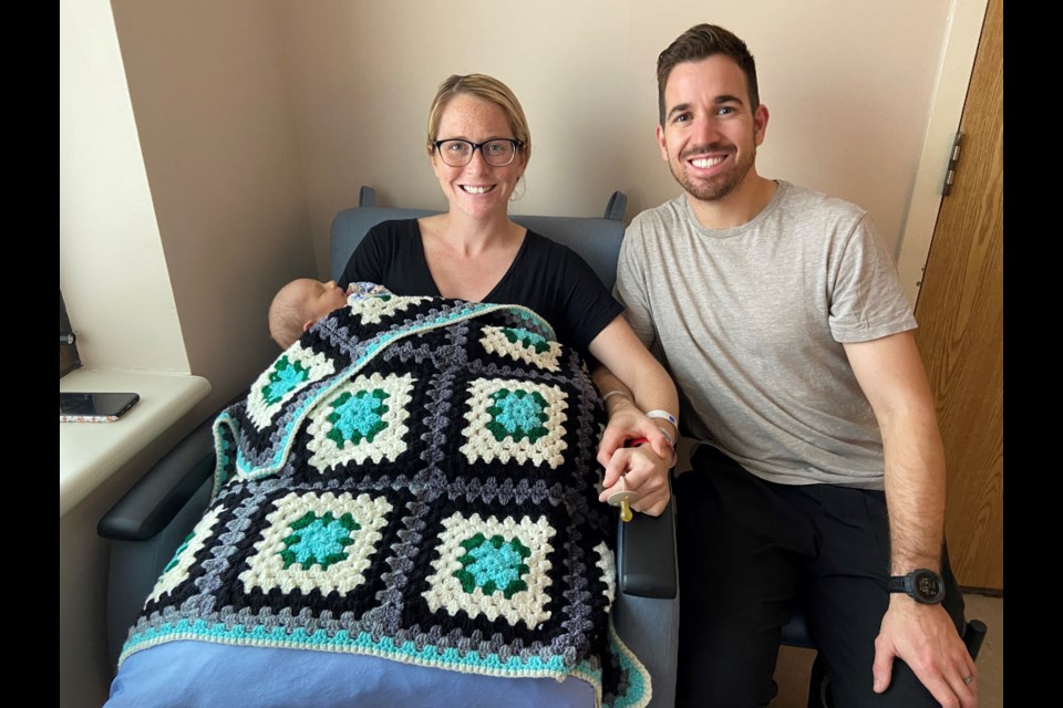 New parents David Archer and Jocelyn Faragher received a knitted blanket that their newborn Kaden 'loves already'.