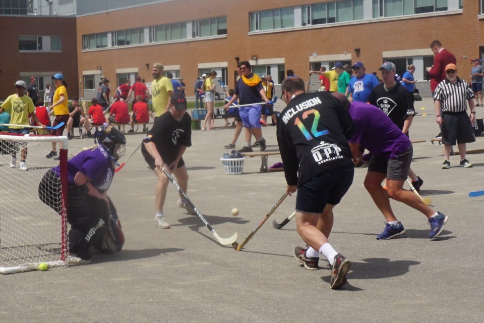   OPP officers, sporting jerseys featuring the word 'inclusion,' take on GBDSS students during a ball hockey tournament.                                   