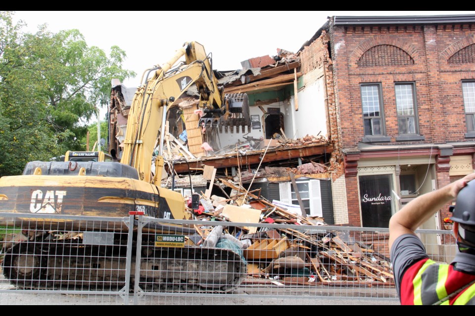 An excavator operator carefully removes items from the partially collapsed building Monday morning at 78 Main St. Penetanguishene. 