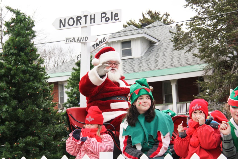 Santa Claus is seen Saturday with some elves at the Midland Santa Claus Parade.