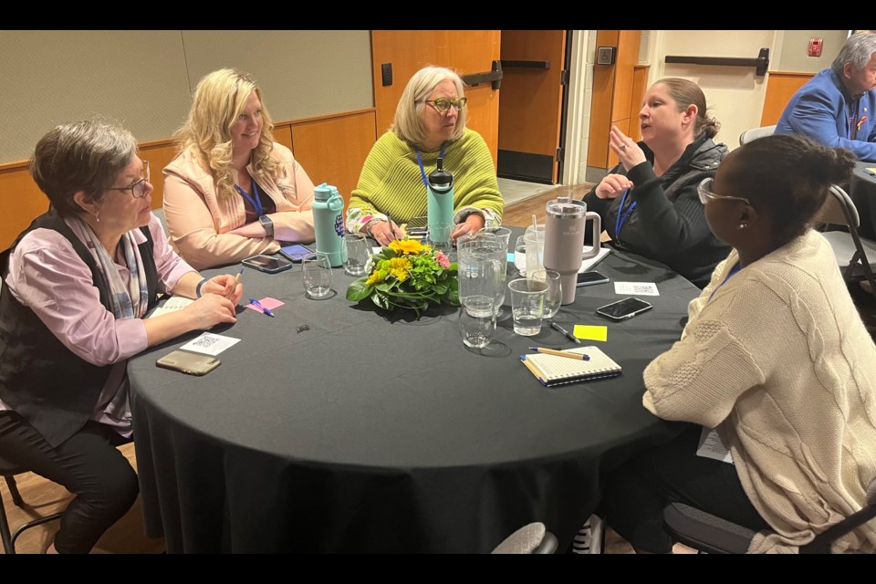 Attendees discuss an issue in this photo from last year's conference.
