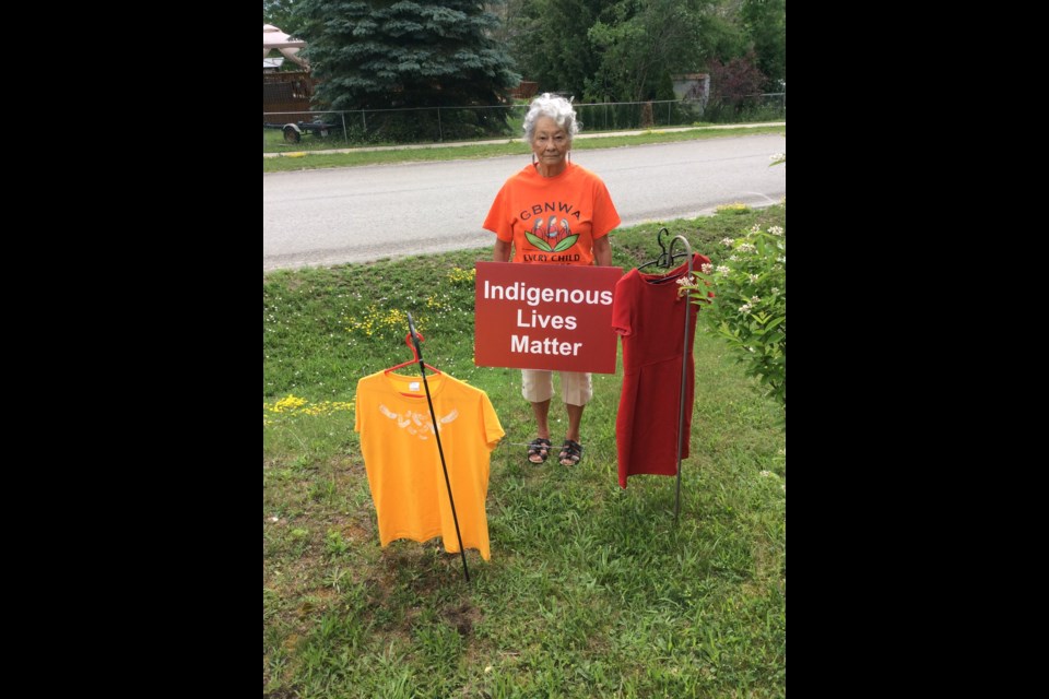 Standing with a red dress for Murdered and Missing Indigenous Women and Orange Shirt says everything you need to know about Lorraine Lacroix’s commitment to reconciliation for her people. Supplied photo