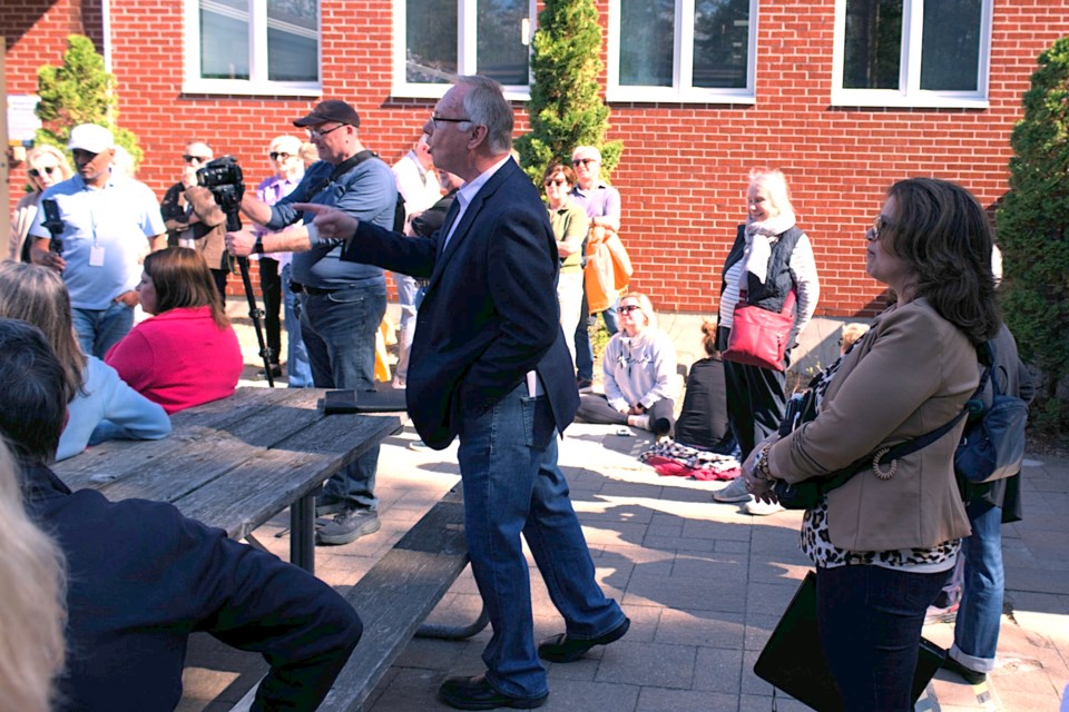 Tiny Township resident Andrew Chomentowski vocally stated his opposition of proposed shoreline management legislation outside Tiny Township council chambers while speaking with a resident in support.