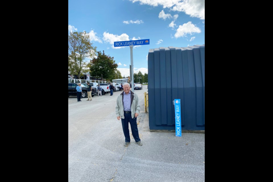 Rick Leaney stands at Rick Leaney Way street sign. Supplied photo