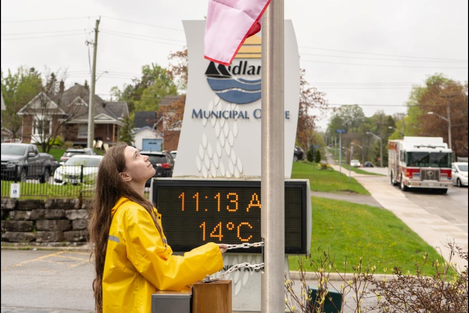 Isabella, from MS Canada, raises the MS flag Midland town hall to proclaim May as Multiple Sclerosis Awareness Month.