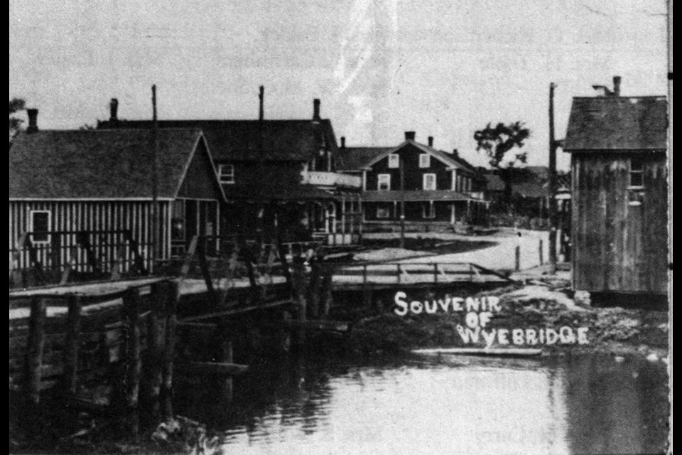 Wyebridge’s early wooden crossing over the impressive Wye River, as seen in this (roughly) 1910 photo, showcases the McRae merchant household in the center with their general store across the street (far right); in the foreground (far left) is an engineer’s office, and in the background is the Dominion Hotel.