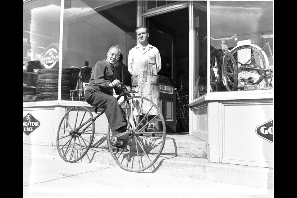 Art Bath, veteran Midland business man tries out this 1860's steel wheeled,  wooden seated bicycle. Eric Eisenberg has it on loan from one of his  bicycle suppliers and featured it at the recent fall fair. Huronia Museum  Free Press Archive, 1955.