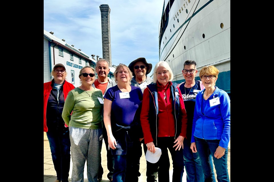 The UNpacking Crew are pictured beside the SS Keewatin at its new Kingston home.