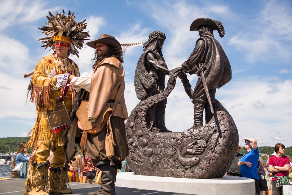 Actors re-enact the meeting of Samuel de Champlain and Chief Aenon in front of the statue called “The Meeting” at the park reopening to celebrate 400 years of Franco-Ontarian culture.