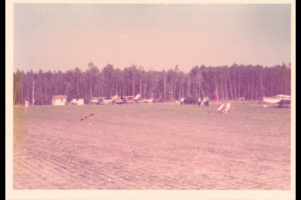 This photo from the 1960s shows the grass strip that operated as the landing strip for the Huronia Airport, the small parking lot, and the terminal.