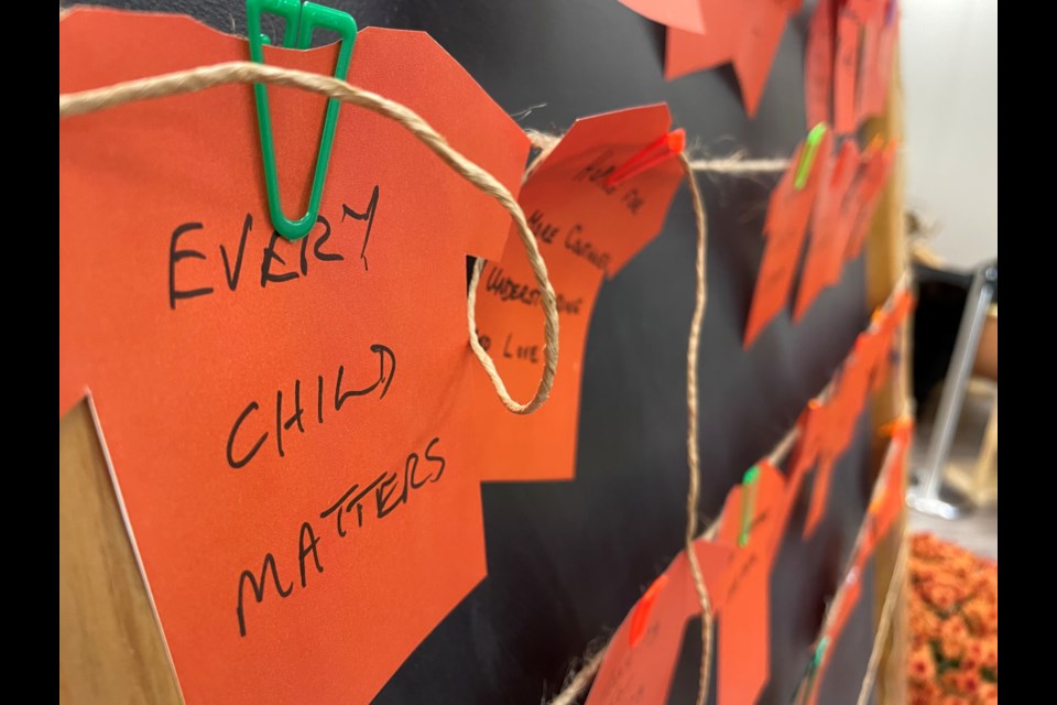 Visitors to Sainte-Marie among the Hurons wrote their thoughts on paper cut-outs of orange T-shirts during the National Day for Truth and Reconciliation in 2022.