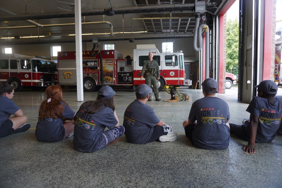 Det.-Const. Brian Anderson and Bauer are pictured in the background during Ignite camp at Midland firehall.                               
