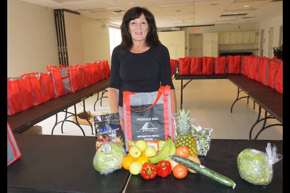 Mary Moreau is pictured with some of the produce bag's contents.                              