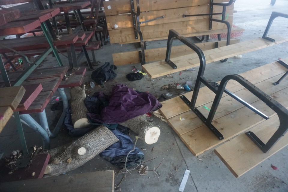 Upturned and broken picnic tables can be found at the shelter along with a varied collection of garbage.