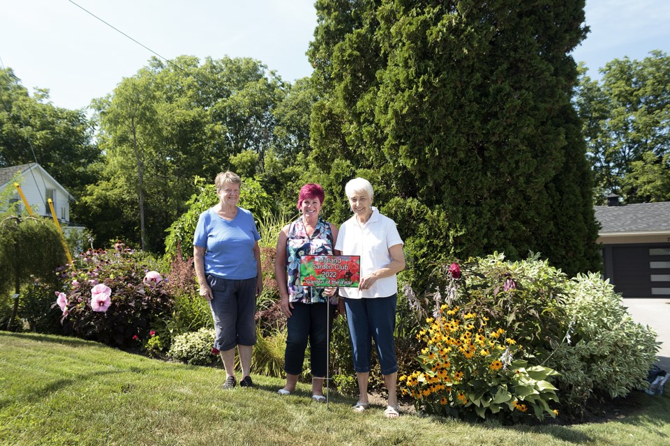 Lori Buckley, centre, was awarded 2022 Garden of the Year by members of the Midland Garden Club this week. President Kay Hawkins, left, and treasurer Diane Marr were on hand to award Buckley a plaque and one year club membership.