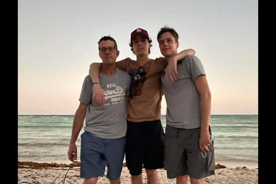 Jaden Marchand is fighting for his life in a Toronto hospital after a work-related incident on his fourth day on the job laying fibre optic cable. He is shown, right, with his dad, Mike, and brother, Evan.