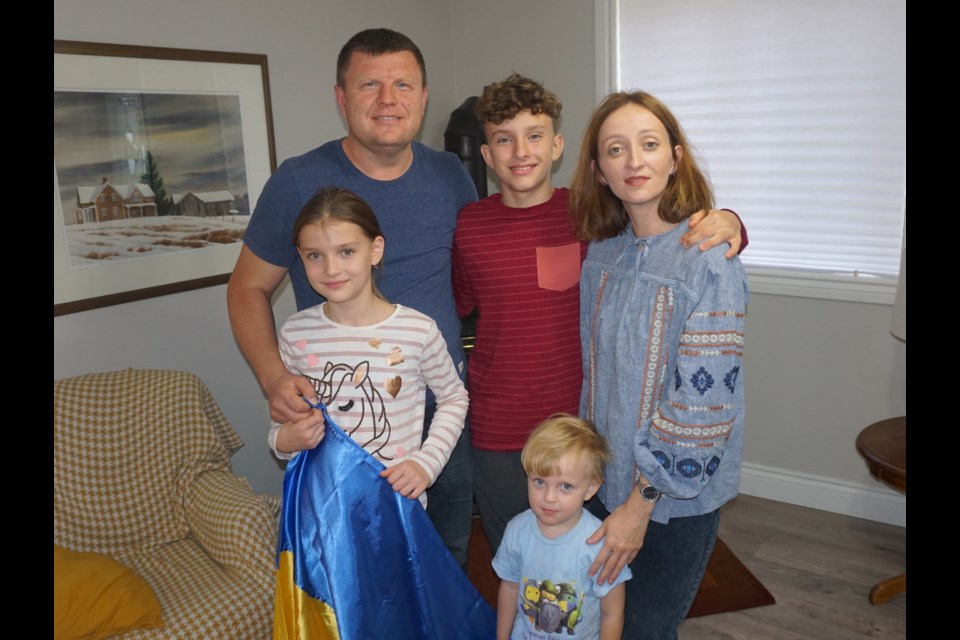 Vyacheslav and Yullia Homa are pictured in their new Midland home with their children Rostyslav, 14, Lisa, 10 and Lev, three.